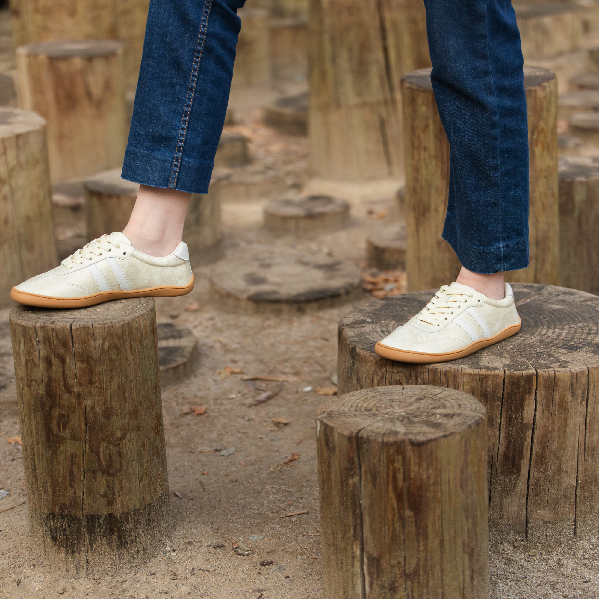 Zapatilla barefoot ergonomica gold modelo Terra para adultos vista frontal en uso sobre troncos